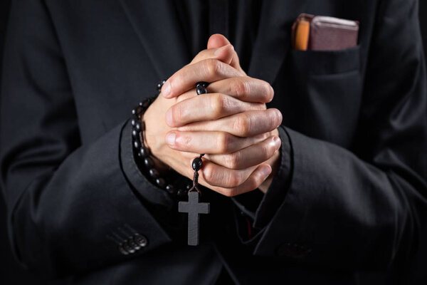 Christian person praying, low key image
