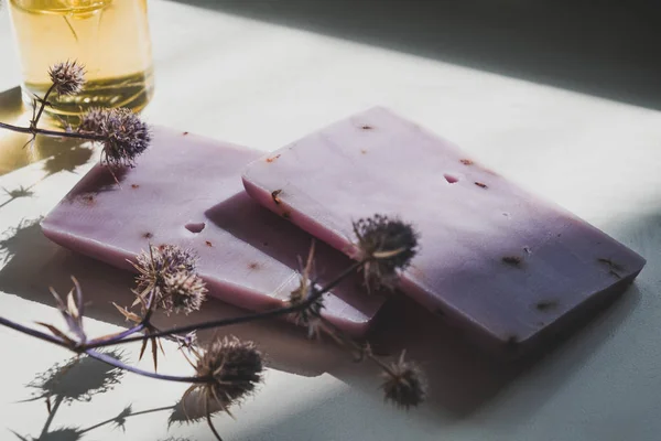 Natural lavender soap bars with dried flowers in natural light. Stock Image