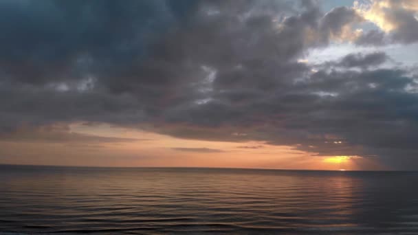 Dunkler Sonnenuntergang Über Der Meeresoberfläche Mit Sonnenstrahlen Reflexionen Zwischen Nimbus — Stockvideo