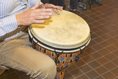 The percussionist uses the bongo to rhythm the song clipart