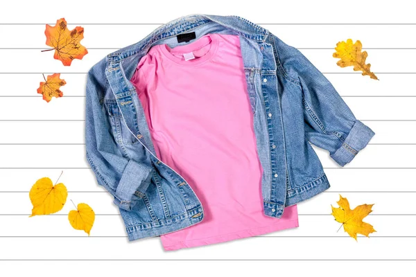 Pink T-shirt and Jeans Jacket on a Wooden Background