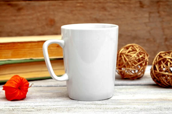 Mug mockup - design template, white cups on a wooden background with books