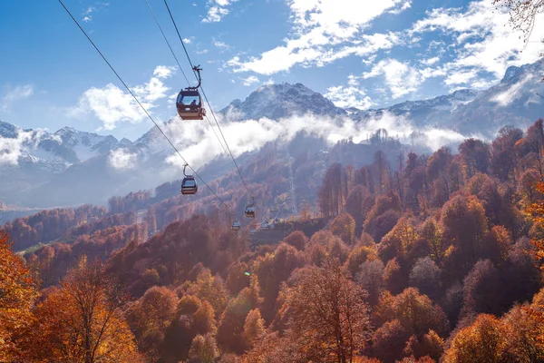 Teleferik ile sonbahar orman görünümünü mavi gökyüzü arka plan üzerinde gözlemleyerek