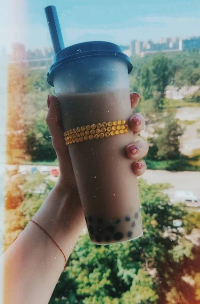 plastic cup with bubble tea, bubble milk tea in hand