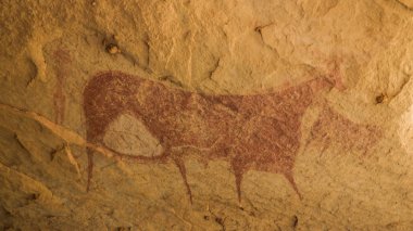 Cave paintings and petroglyphs in Terkei Cave aka biggest cow in Ennedi, Chad clipart