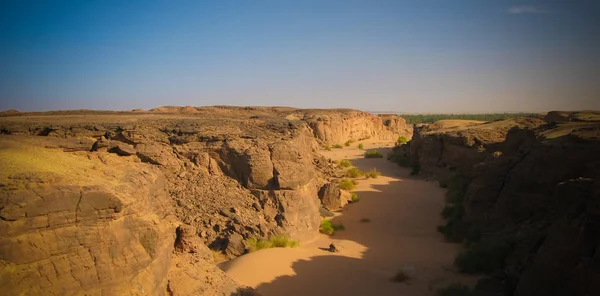 Desert landscape with dry riverbed aka wadi at Karima, Sudan