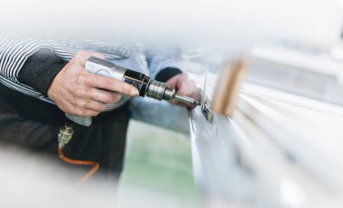 Alüminyum ve PVC profilleri kesen el işi işçisi. İmalat işleri. Seçici odaklanma. Alüminyum ve PVC pencere ve kapı üretim fabrikası.