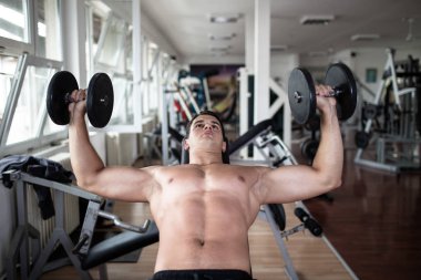 Fitness salonunda egzersiz genç çekici yetişkin bir adam. Kapalı eğitim spor.