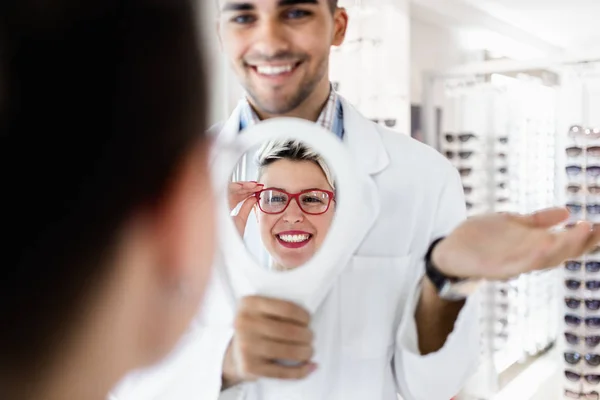 Genç Optometrist Müşteriye Sağ Gözlük Seçmesinde Yardımcı Olur — Stok fotoğraf