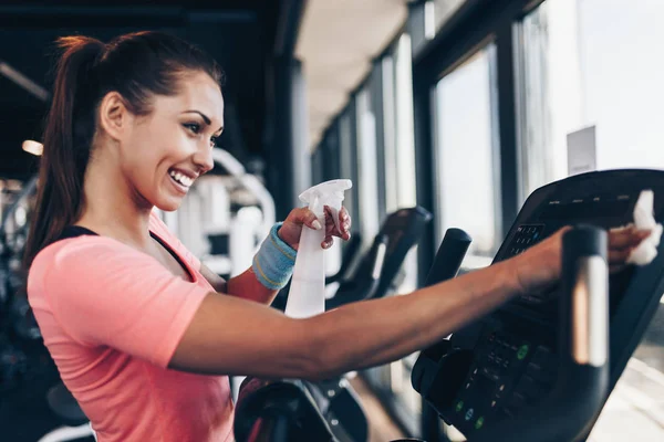 Young Happy Smiling Woman Cleaning Weeping Expensive Fitness Gym Equipment — Stock Photo, Image