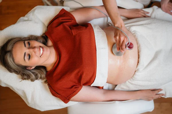 Profesyonel güzellik uzmanı, müşterinin vücudunda yağ azaltma ve vücut şekillendirme, kaplıca ortamında sağlığın ve güzelliğin teşviki için dişçilik yapıyor.