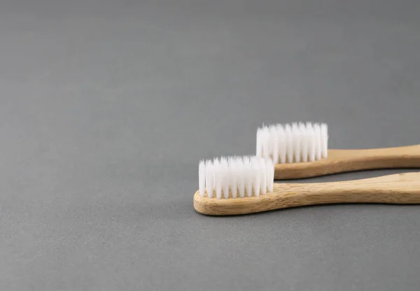 Close up wooden toothbrush on grey background, selective focus — Stock Photo, Image