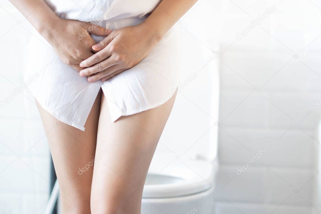 Close up woman stomachache with toilet in the morning, health care concept, selective focus