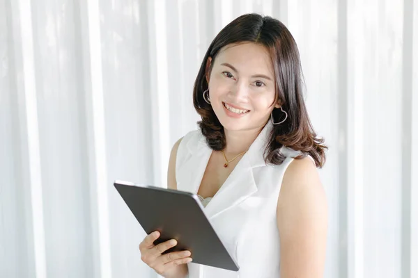 Business woman hand holding digital tablet computer with graph of Binary option for trading platform, setective focus