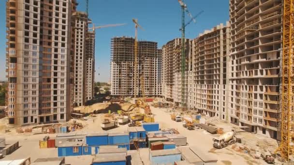 Construction of houses. Drone fly over construction site with tower cranes — Stock Video