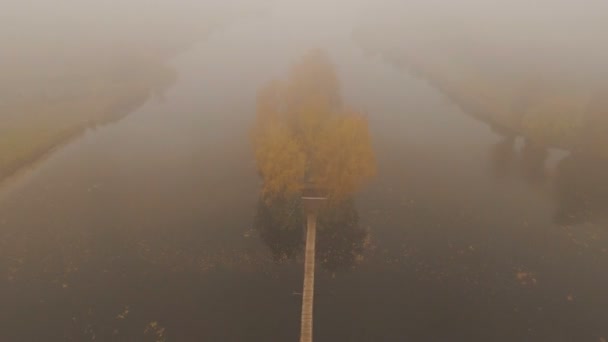 Казковий будинок посеред озера на осінньому туманному ранковому повітрі — стокове відео