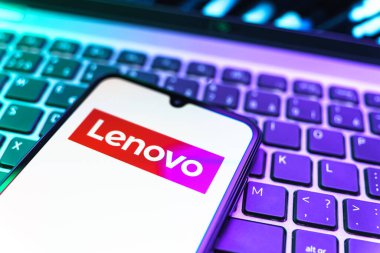 Prag, Çek Cumhuriyeti - 08 19 2025: Klavyede duran ve Lenovo logosunu gösteren bir cep telefonunun yakından görüntüsü. Lenovo bilgisayar ve elektronik üreten bir teknoloji şirketidir..