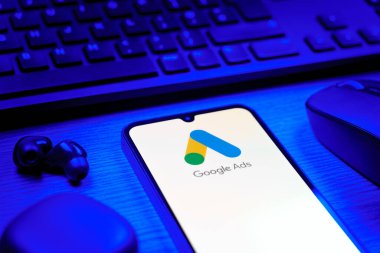 Prag, Çek Cumhuriyeti - 08 12 2025: Google Ads logosunu gösteren klavyesi ve cep telefonu olan bir masanın yan görüntüsü. Google Reklamları, çevrimiçi reklamlar yaratmak ve yönetmek için bir platformdur.