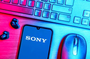 Prague, Czechia - 08 09 2025: A top-down view of a desk with a phone displaying the Sony logo. Sony is a tech company producing electronics, games, and entertainment.