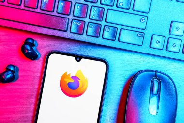 Prague, Czechia - 08 09 2025: A top-down view of a desk with a phone displaying the Firefox logo. Firefox is a web browser for fast and secure internet browsing.