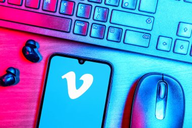 Prague, Czechia - 08 09 2025: A top-down view of a desk with a phone displaying the Vimeo logo. Vimeo is a platform for hosting and sharing high-quality videos.