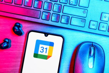 Prague, Czechia - 08 09 2025: A top-down view of a desk with a phone displaying the Google Calendar logo. Google Calendar is a platform for scheduling and managing events.