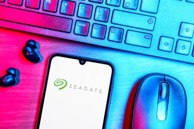 Prague, Czechia - 08 09 2025: A top-down view of a desk with a phone displaying the Seagate logo. Seagate is a company producing hard drives and storage solutions.