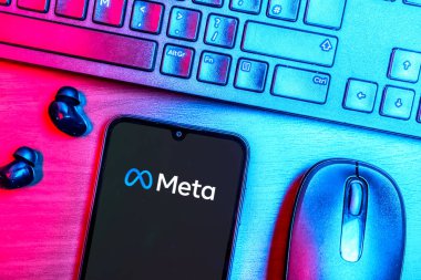 Prague, Czechia - 08 09 2025: A top-down view of a desk with a phone displaying the Meta logo. Meta is a company offering social platforms like Facebook and Instagram.