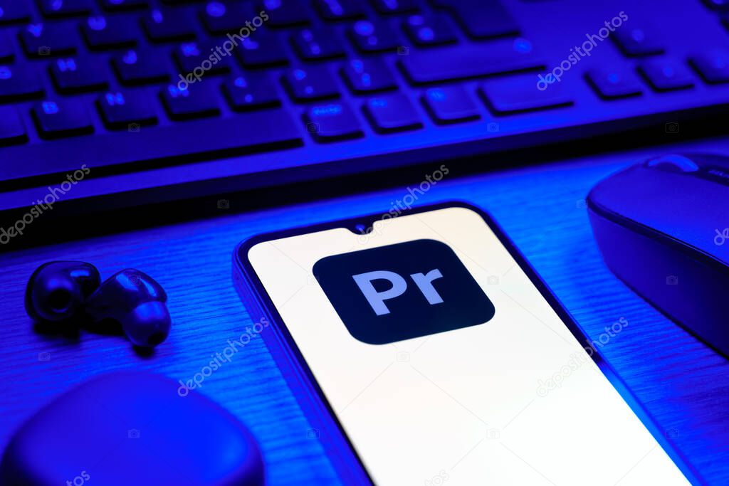 Prague, Czechia - 08 12 2025: A side view of a desk with a keyboard and a mobile phone displaying the Slack logo. Slack is a platform for team messaging and workplace communication.