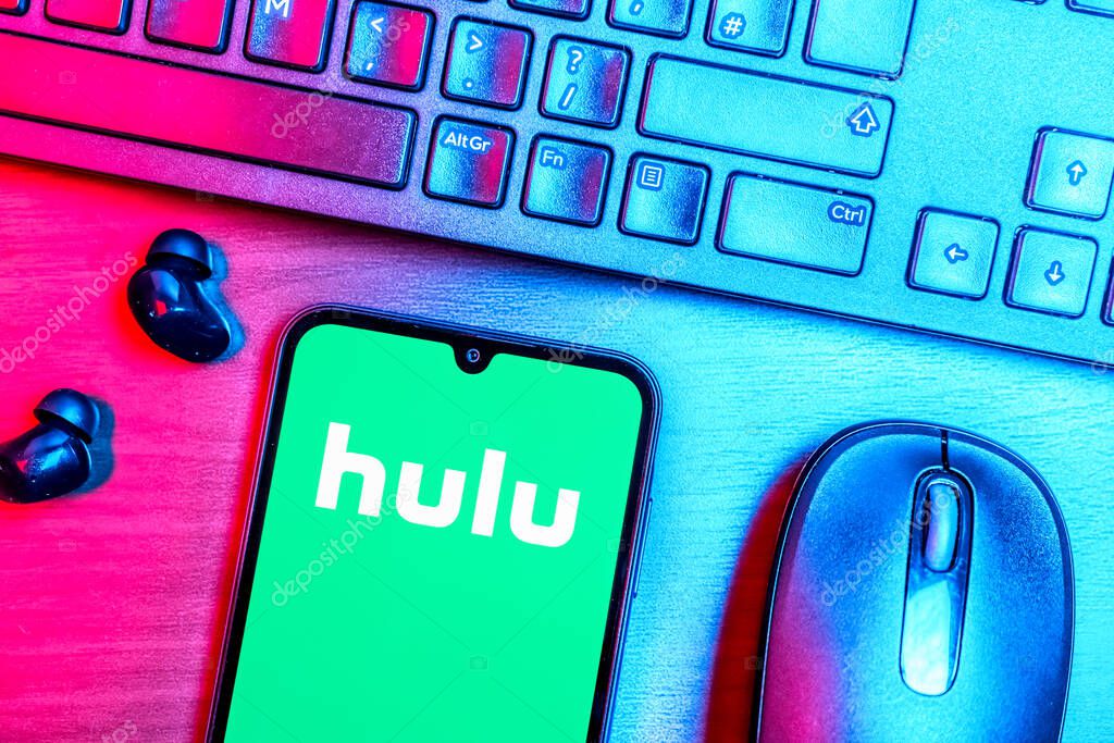 Prague, Czechia - 08 09 2025: A top-down view of a desk with a phone displaying the Hulu logo. Hulu is a streaming platform for TV shows, movies, and live TV.