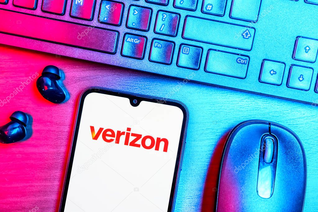 Prague, Czechia - 08 09 2025: A top-down view of a desk with a phone displaying the Verizon logo. Verizon is a telecom company providing wireless and broadband services.