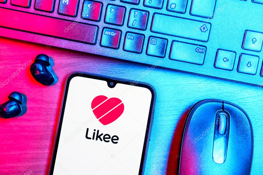 Prague, Czechia - 08 09 2025: A top-down view of a desk with a phone displaying the Likee logo. Likee is a platform for creating and sharing short videos.