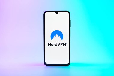 Prag, Çek Cumhuriyeti - 08 10 2025: Arka planda duran bir cep telefonu NordVPN logosunu gösteriyor. NordVPN güvenli ve özel internet taraması için bir platformdur.