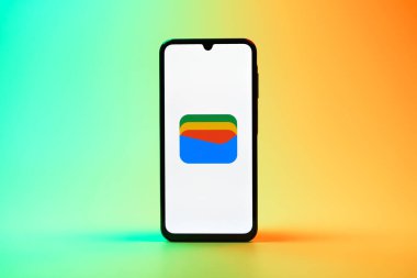 Prag, Çek Cumhuriyeti - 08 10 2025: Tek tip arka planda duran bir cep telefonu Google Cüzdan logosunu görüntüler. Google Cüzdanı dijital ödeme yöntemlerini depolamak ve kullanmak için bir platformdur.