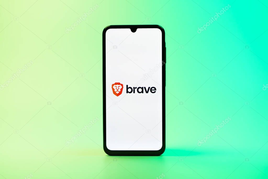 Prague, Czechia - 08 10 2025: A mobile phone standing on a uniform background displays the Brave logo. Brave is a web browser focused on privacy and speed.