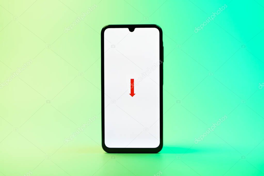 Prague, Czechia - 08 10 2025: A mobile phone standing on a uniform background displays the FedEX logo. FedEX is a logistics company providing shipping and courier services.