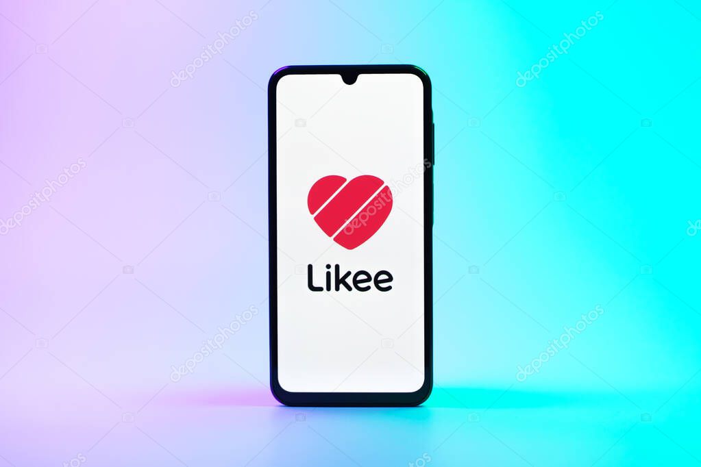 Prague, Czechia - 08 10 2025: A mobile phone standing on a uniform background displays the Likee logo. Likee is a platform for creating and sharing short videos.