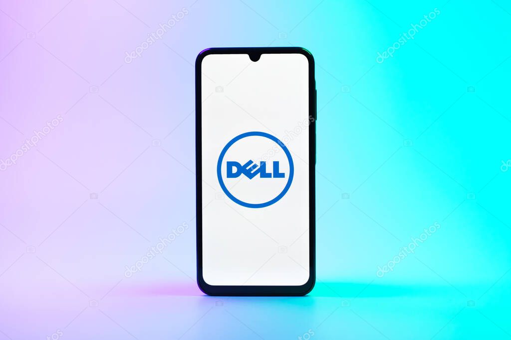 Prague, Czechia - 08 10 2025: A mobile phone standing on a uniform background displays the Dell logo. Dell is a technology company producing computers and IT solutions.