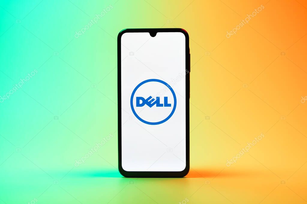 Prague, Czechia - 08 10 2025: A mobile phone standing on a uniform background displays the Dell logo. Dell is a technology company producing computers and IT solutions.