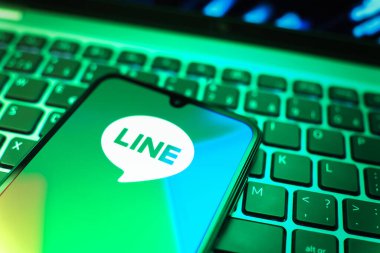 Prag, Çek Cumhuriyeti - 08 19 2025: Bir cep telefonunun klavyede duran ve hat logosunu gösteren yakın plan görüntüsü. Line aramalar, mesajlar ve çokluortam paylaşımı için bir mesajlaşma uygulamasıdır.