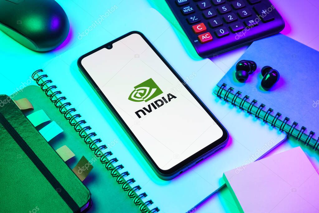 Prague, Czechia - 08 18 2025: An arrangement of office supplies with a mobile phone in the center displaying NVIDIA logo. NVIDIA is a technology company specializing in GPUs and AI hardware.