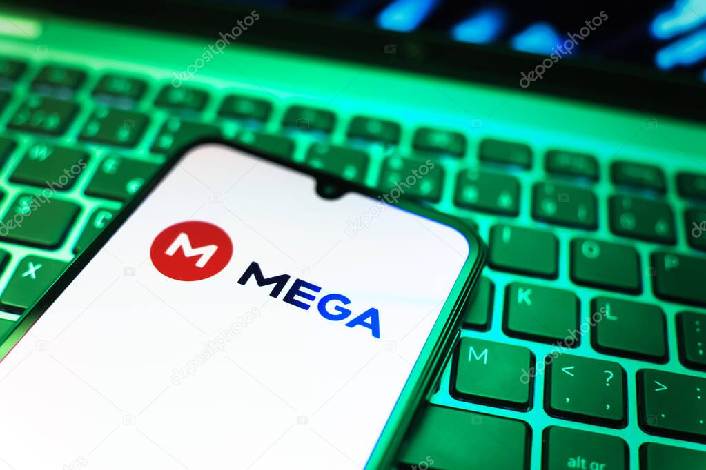 Prague, Czechia - 08 19 2025: A close-up view of a mobile phone lying on a keyboard, displaying Mega logo. Mega is a platform for cloud storage with encrypted file sharing.
