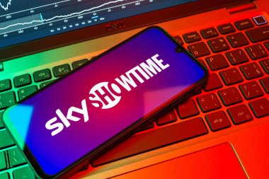 Prag, Çek Cumhuriyeti - 08 18 2025: Klavyede bir cep telefonu SkyShowtime logosu sergiler. SkyShowtime, sinema ve televizyon dizileri için bir yayın platformudur..