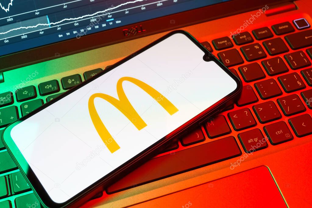 Prague, Czechia - 08 18 2025: A mobile phone on a keyboard displays McDonalds logo. McDonalds is a fast-food chain serving burgers, fries, and more.