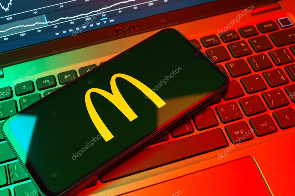 Prague, Czechia - 08 18 2025: A mobile phone on a keyboard displays McDonalds logo. McDonalds is a fast-food chain serving burgers, fries, and more.