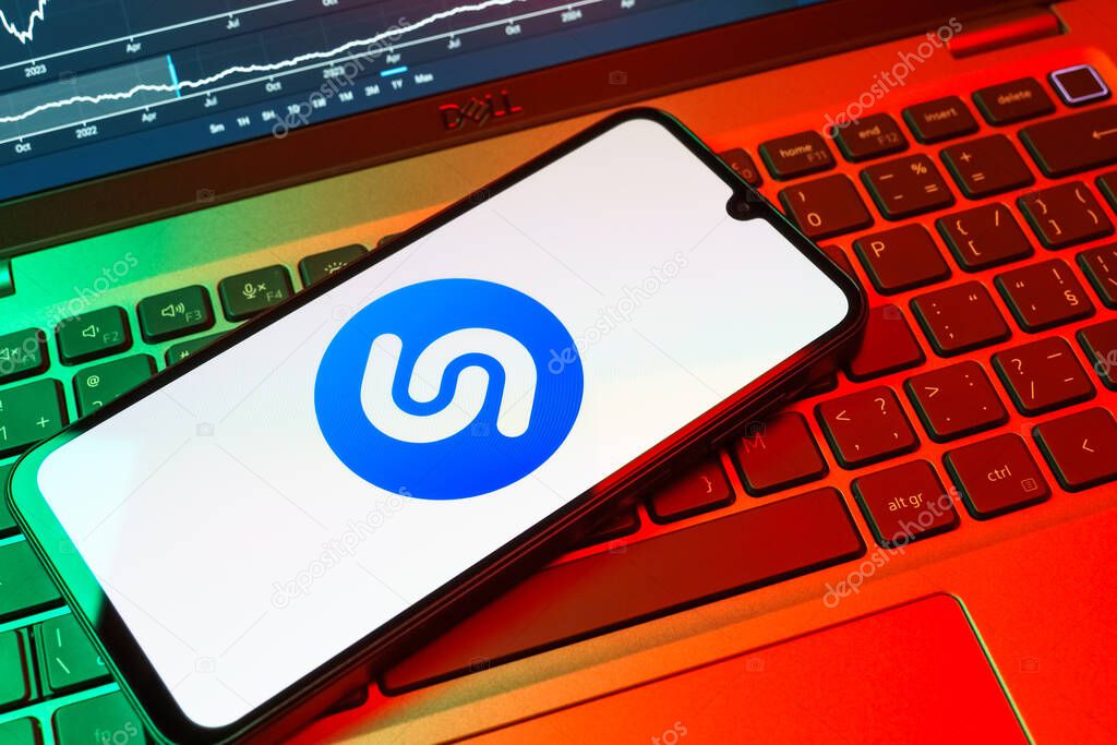Prague, Czechia - 08 18 2025: A mobile phone on a keyboard displays Shazam logo. Shazam is an app for identifying songs and music tracks.
