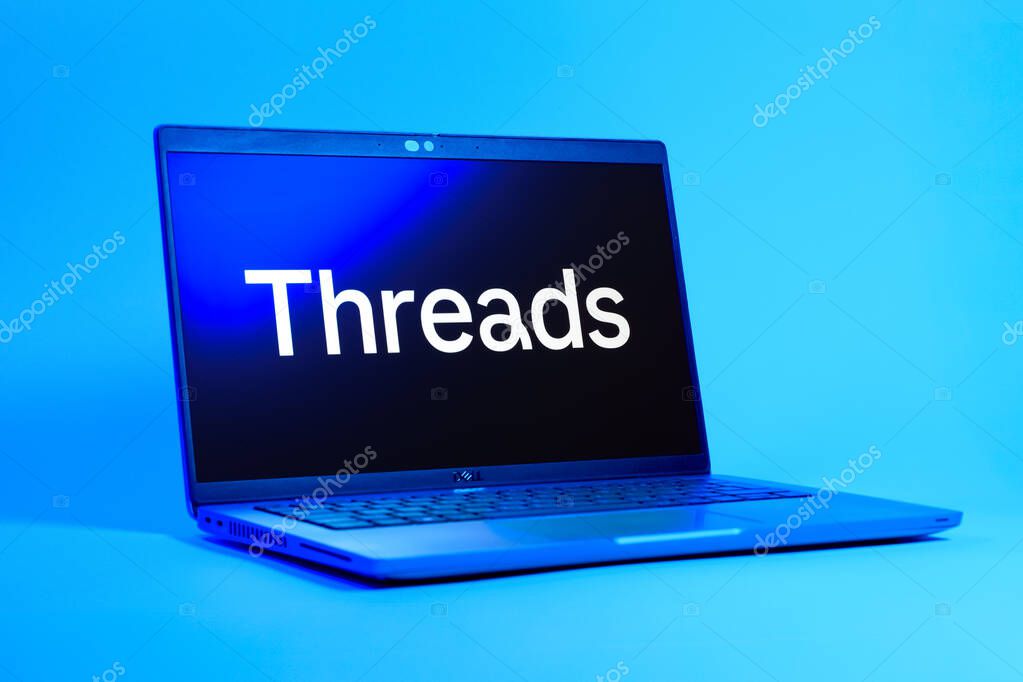 Prague, Czechia - 05 18 2025: A low-angle view of a laptop displaying Threads logo. Threads is a social media platform for sharing short posts and updates.
