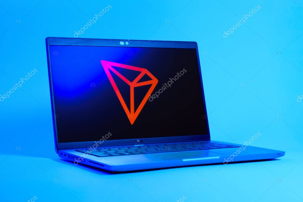 Prague, Czechia - 05 18 2025: A low-angle view of a laptop displaying Tron logo. Tron is a blockchain platform for decentralized applications.