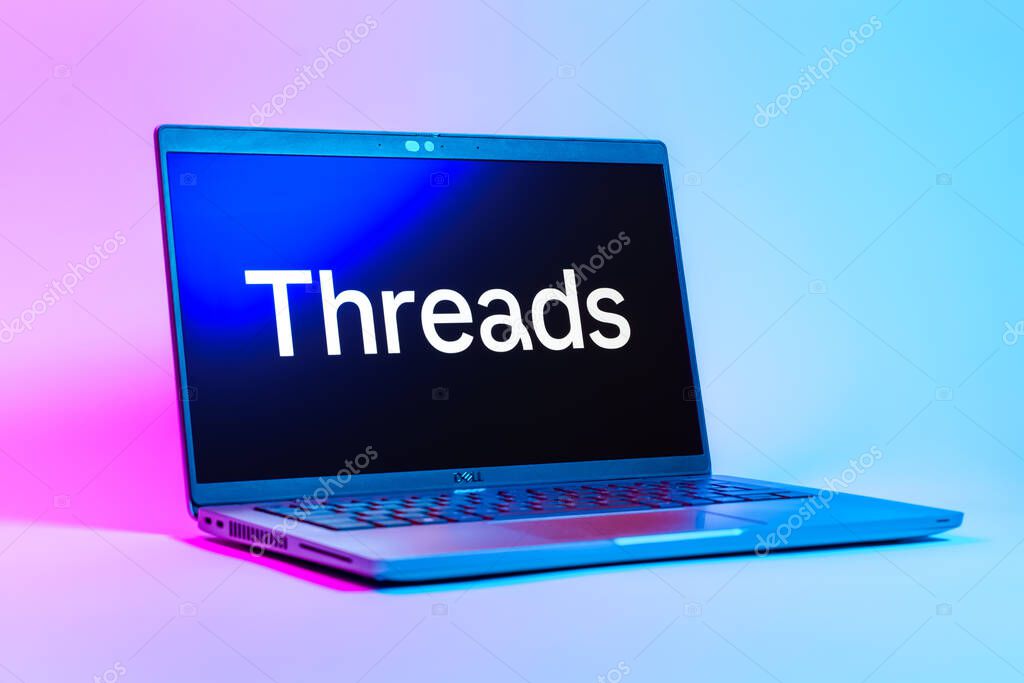 Prague, Czechia - 05 18 2025: A low-angle view of a laptop displaying Threads logo. Threads is a social media platform for sharing short posts and updates.