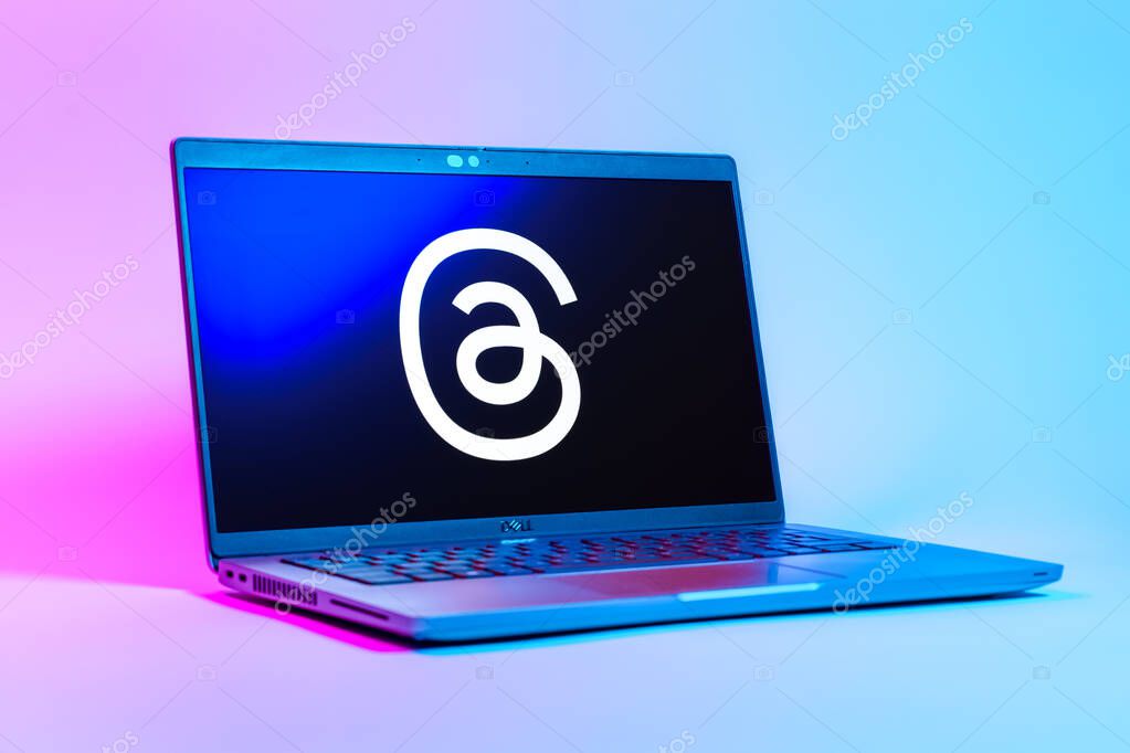 Prague, Czechia - 05 18 2025: A low-angle view of a laptop displaying Threads logo. Threads is a social media platform for sharing short posts and updates.